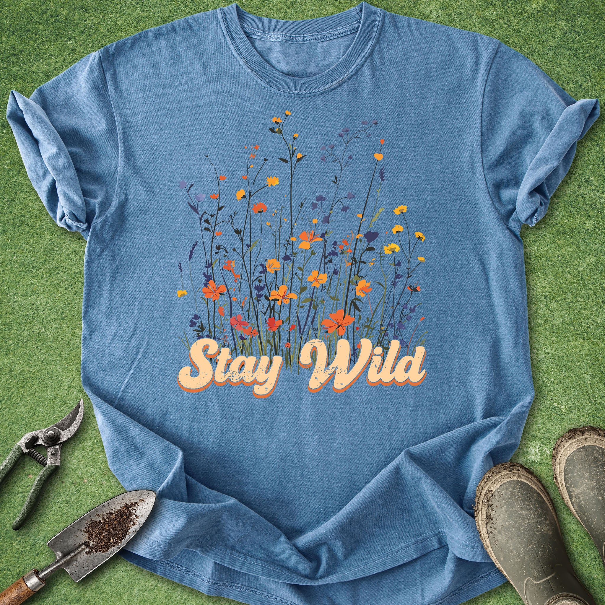 Blue t-shirt with colorful wildflowers and “Stay Wild” text design