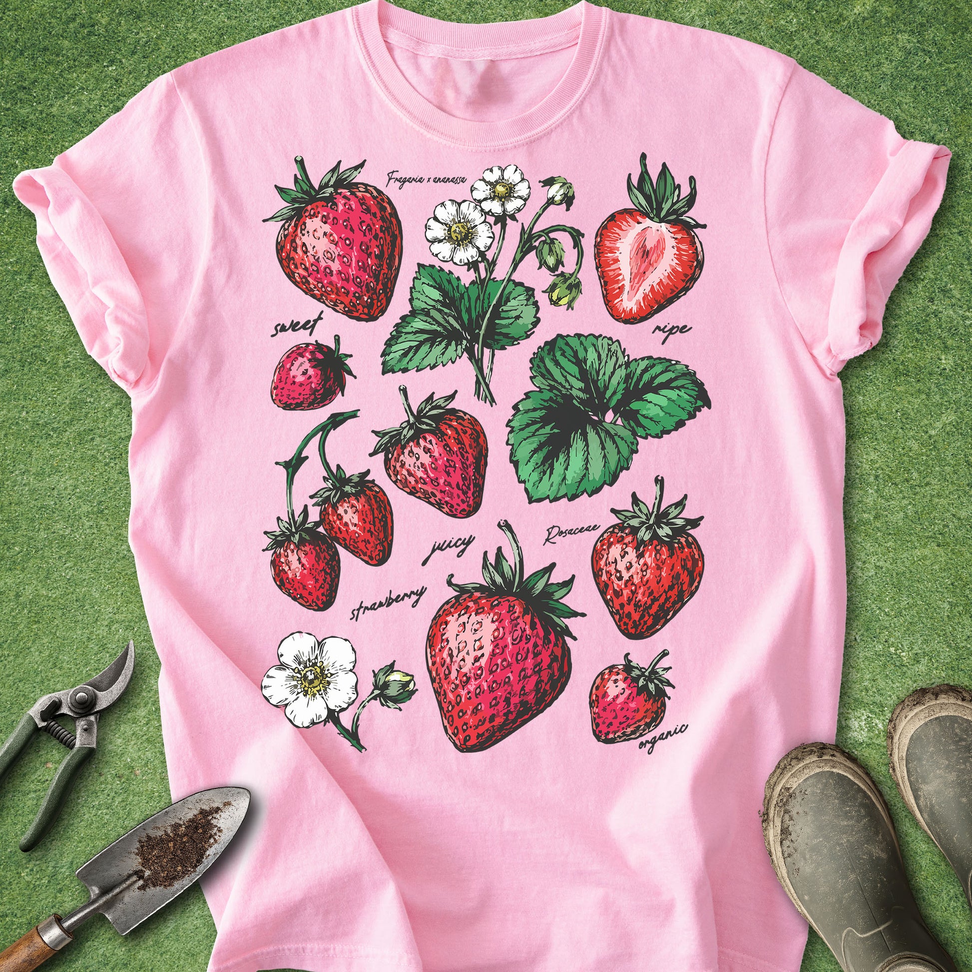 Pink t-shirt with strawberry design on a green background