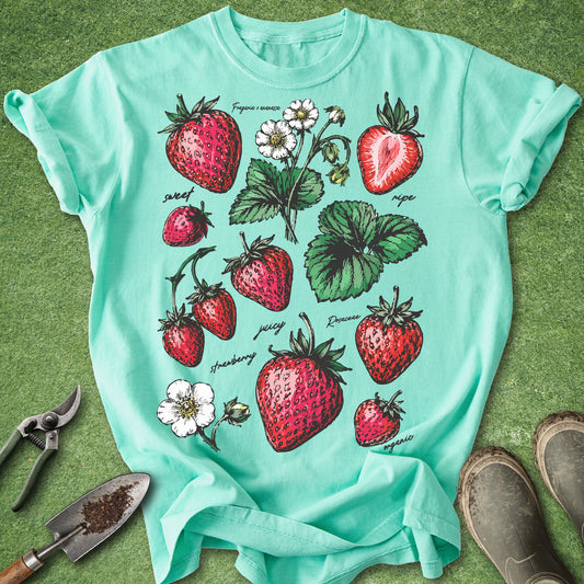 Island Reef Comfort Colors t-shirt featuring vintage botanical illustrations of strawberries, strawberry blossoms, and leaves in vibrant red and green colors, perfect for gardeners and berry lovers.