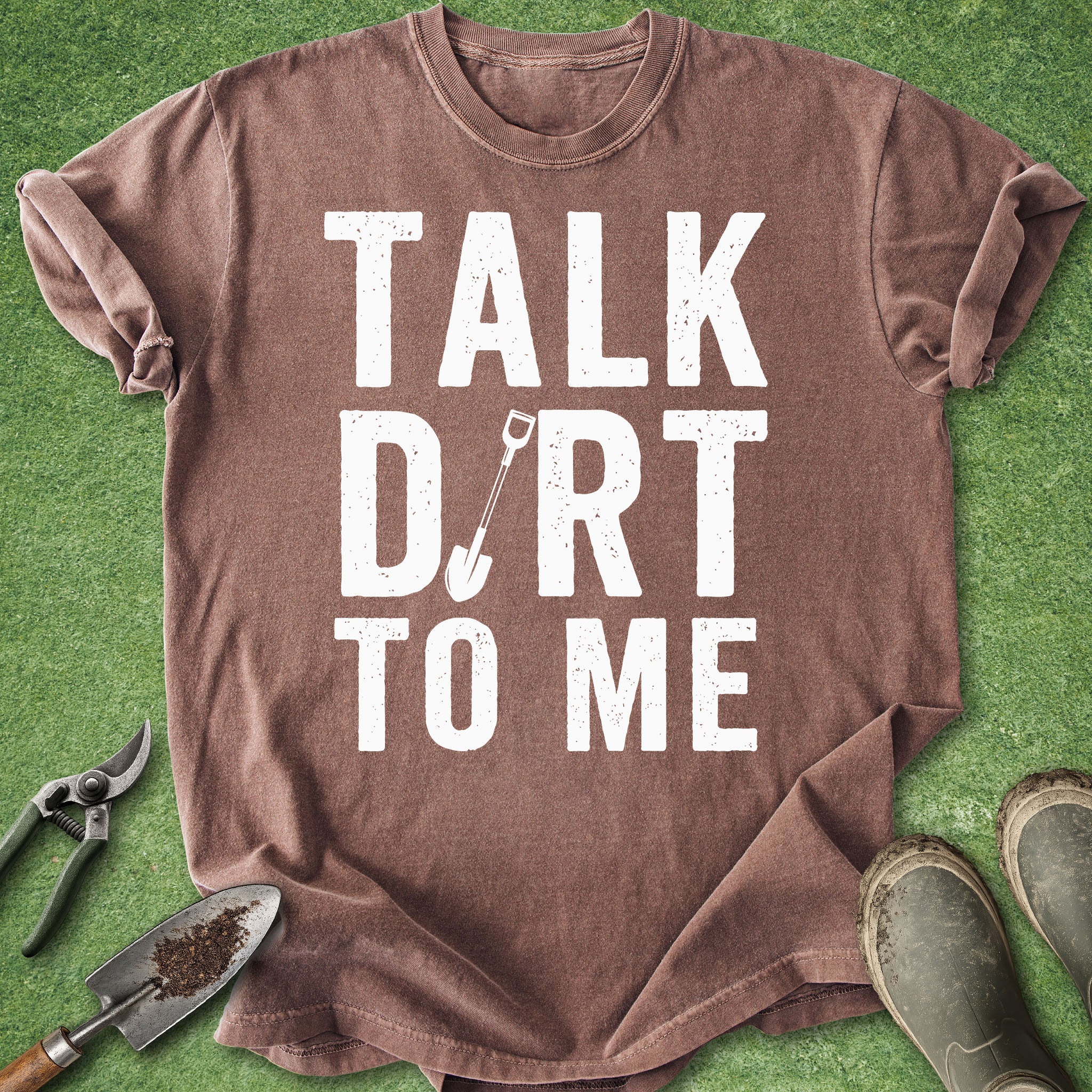 Brown t-shirt with 'Talk Dirt to Me' text on a green background with gardening tools.