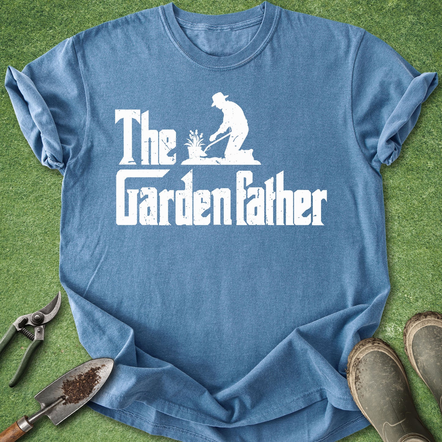 Blue t-shirt with 'The Garden Father' text and graphic on a grass background
