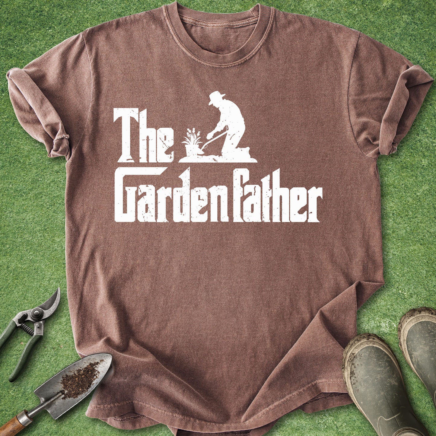 Brown t-shirt with 'The Garden Father' graphic on a green grass background