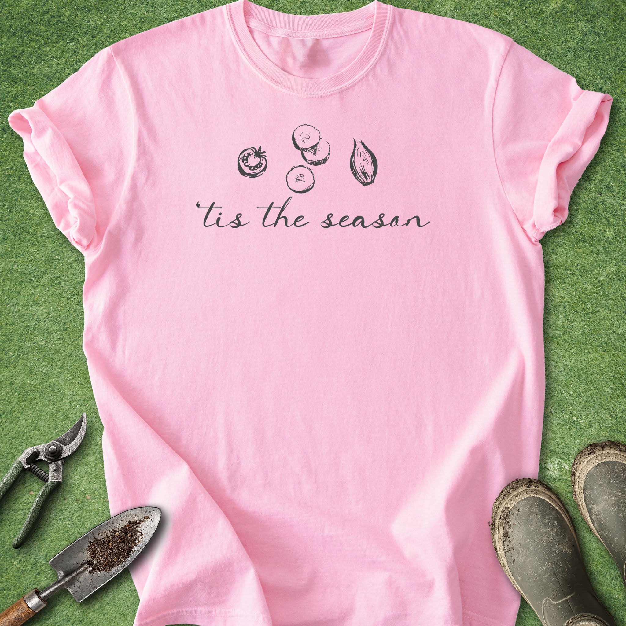 Pink t-shirt with 'tis the season text and graphics on a green background