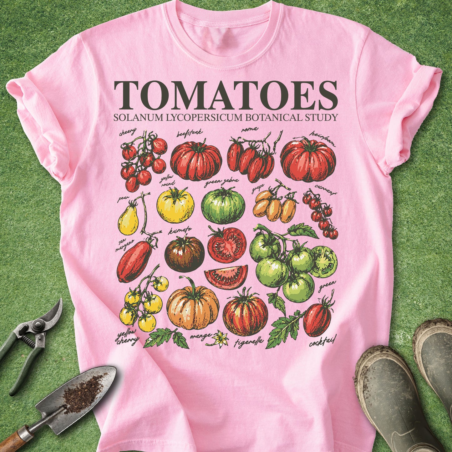 Pink t-shirt with tomato illustrations and text on a green background