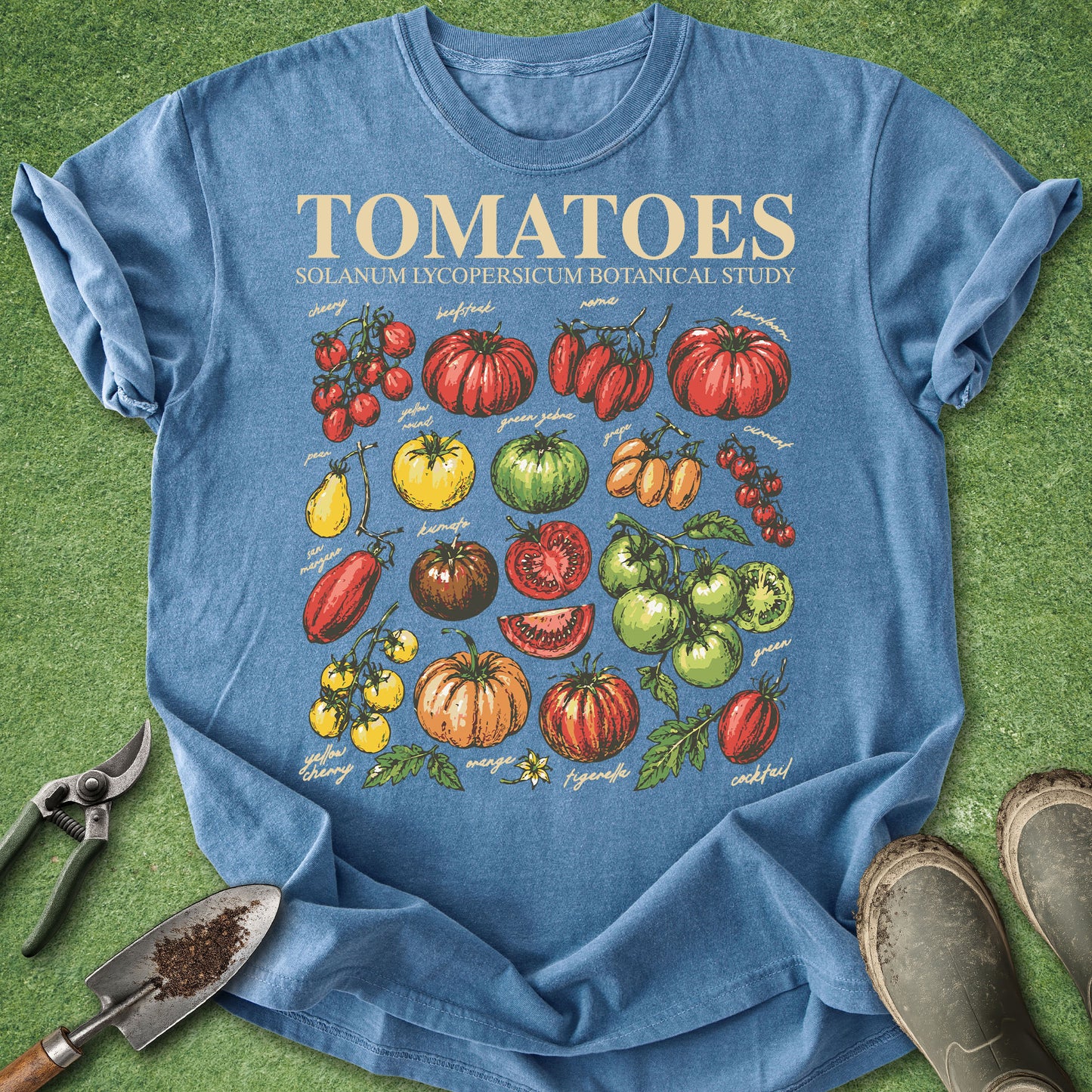 Blue t-shirt with tomato illustrations on a grass background