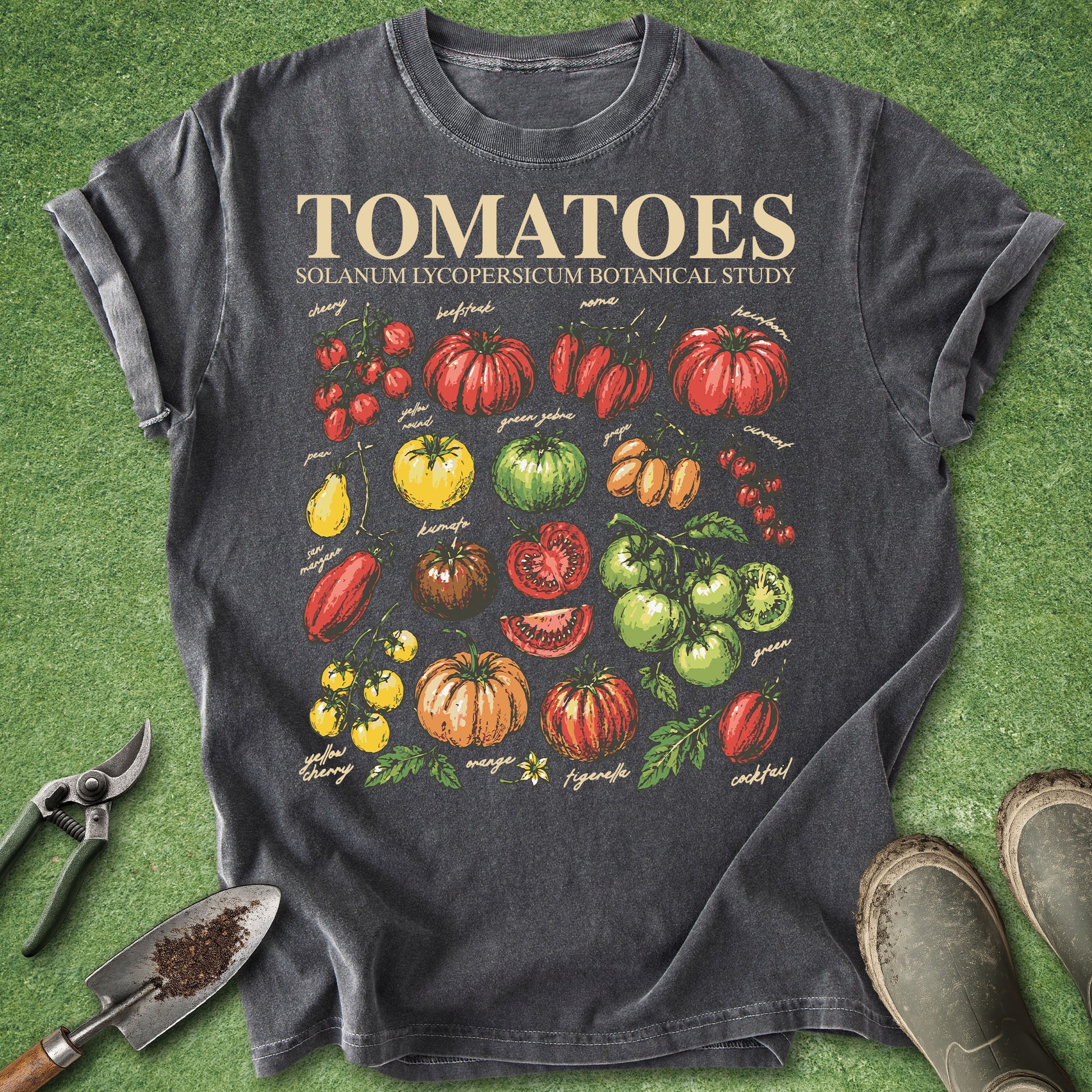 Dark gray t-shirt with tomato graphic and text on a green grass background