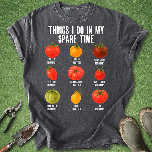 Pepper gray t-shirt featuring the phrase "Things I Do in My Spare Time" above nine illustrated tomatoes labeled with humorous gardening activities like watering, researching, picking, and eating tomatoes.