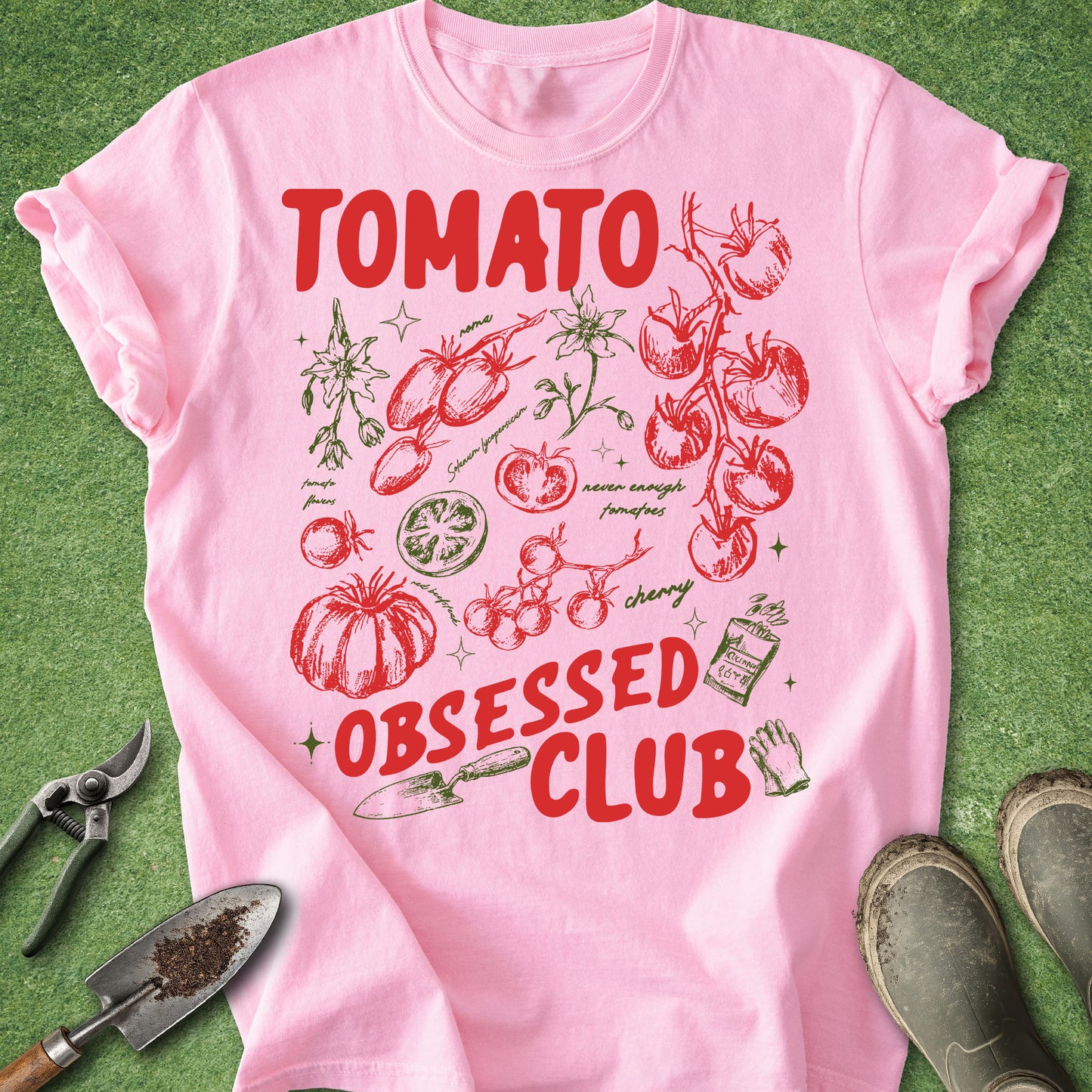 Pink t-shirt with tomato-themed design on a green background