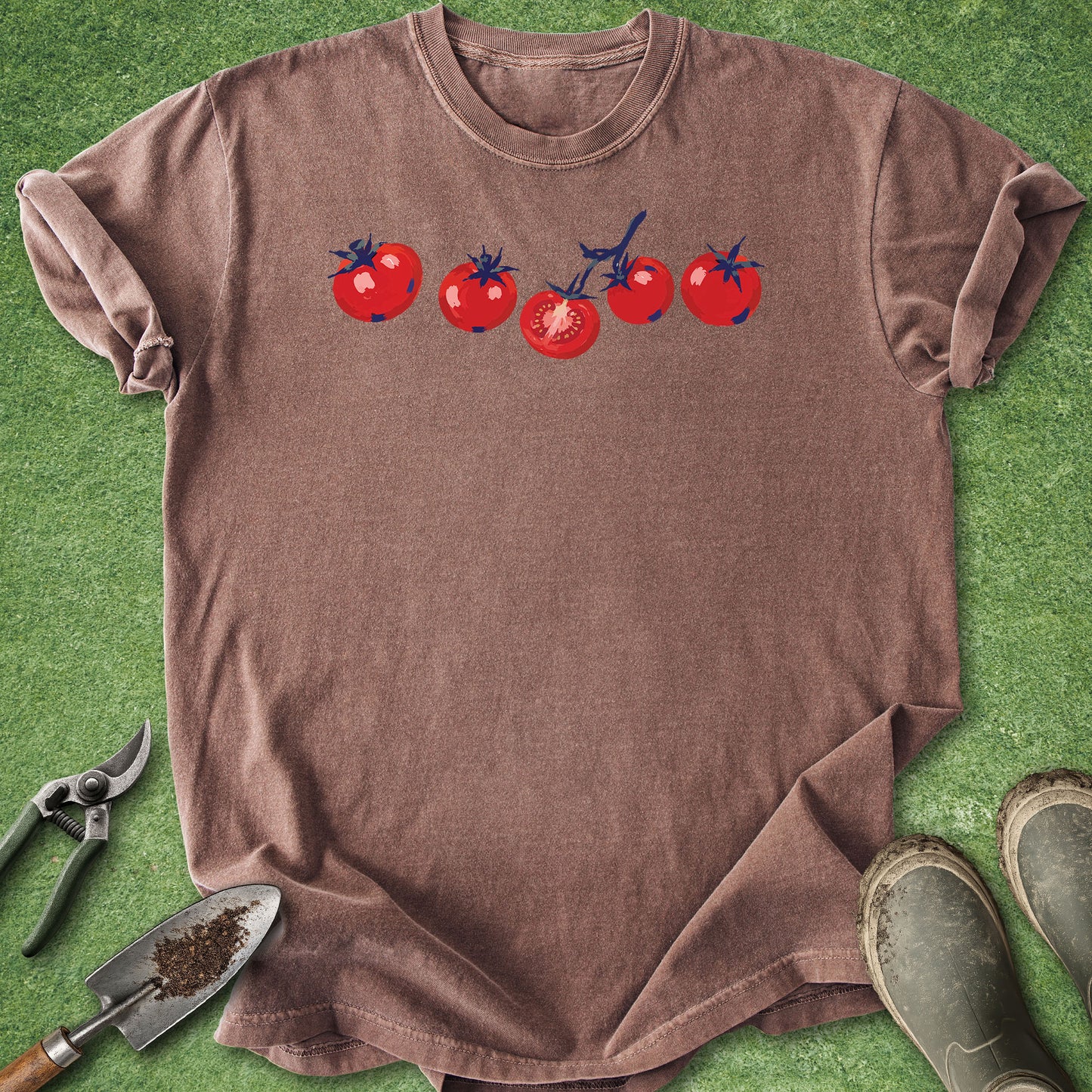 Brown t-shirt with tomato design on a green grass background