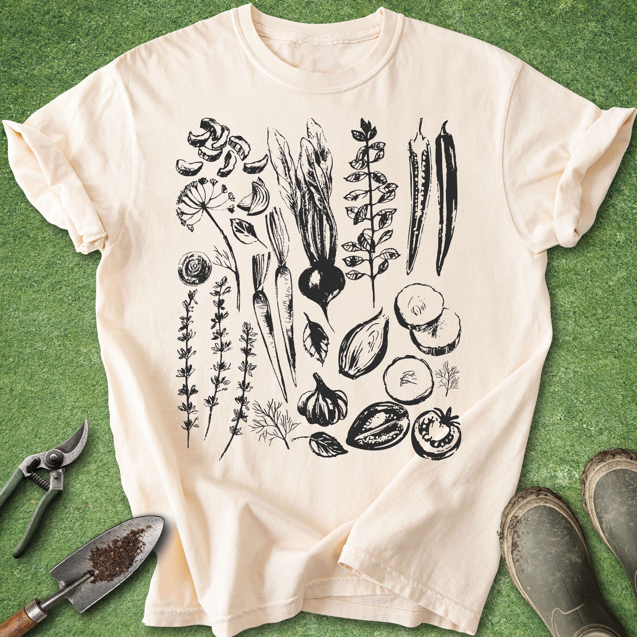 Beige t-shirt with black botanical illustrations on a green background