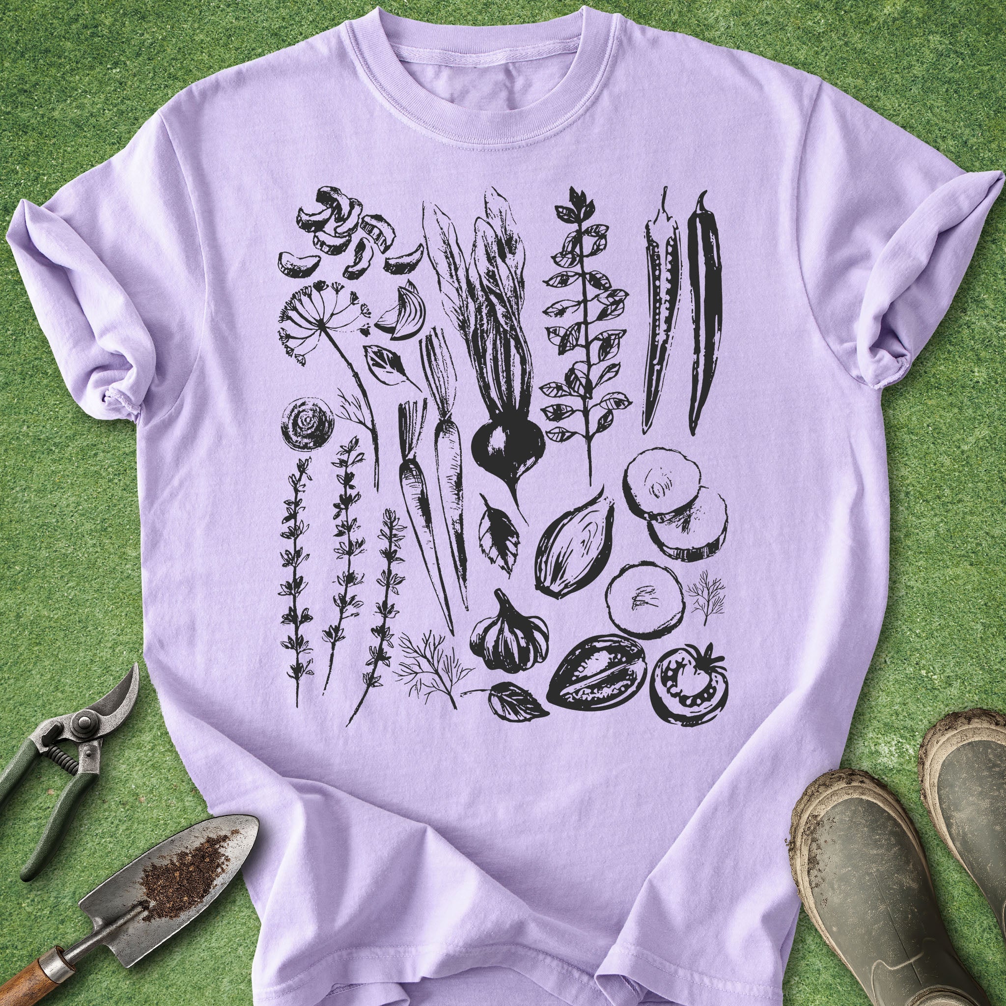 Purple t-shirt with black botanical illustrations on a green background