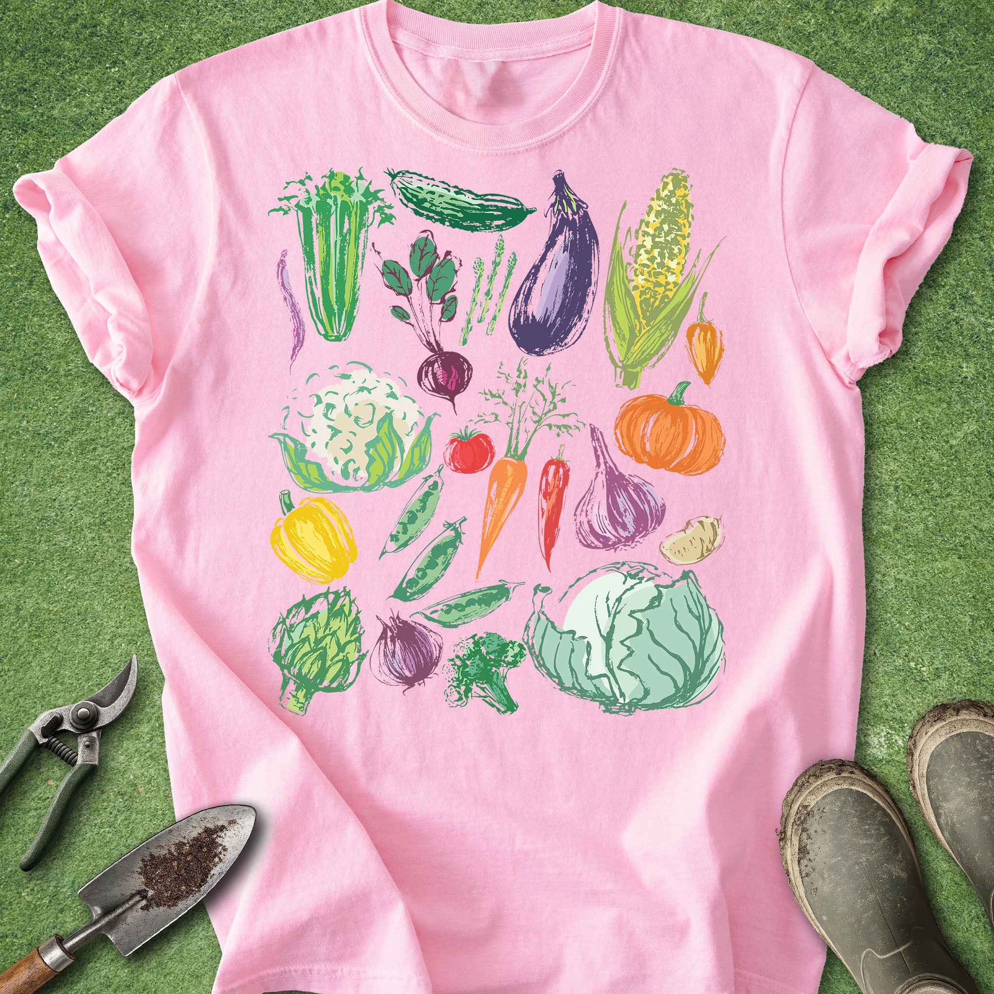 Pink t-shirt with colorful vegetable graphics on a green background