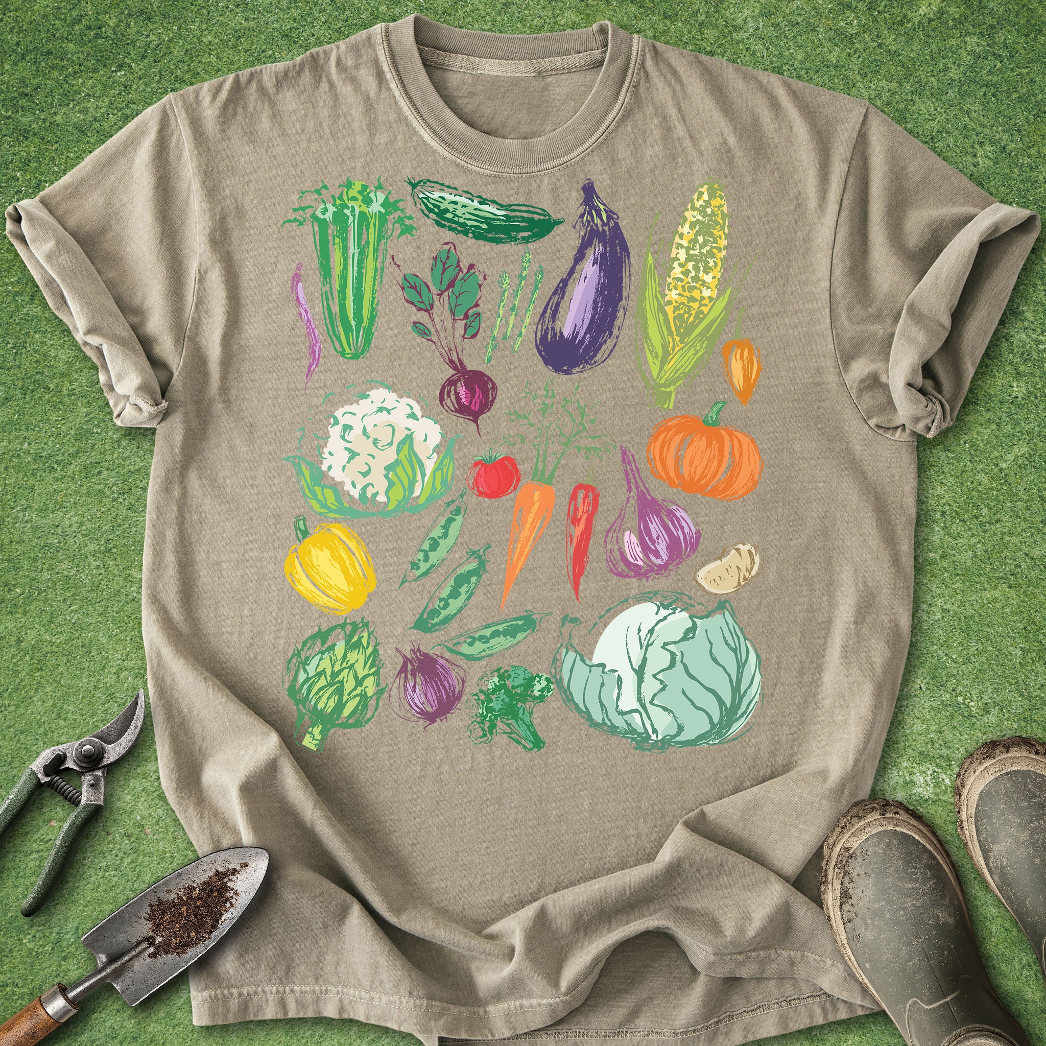 Beige t-shirt with colorful vegetable illustrations on a green background