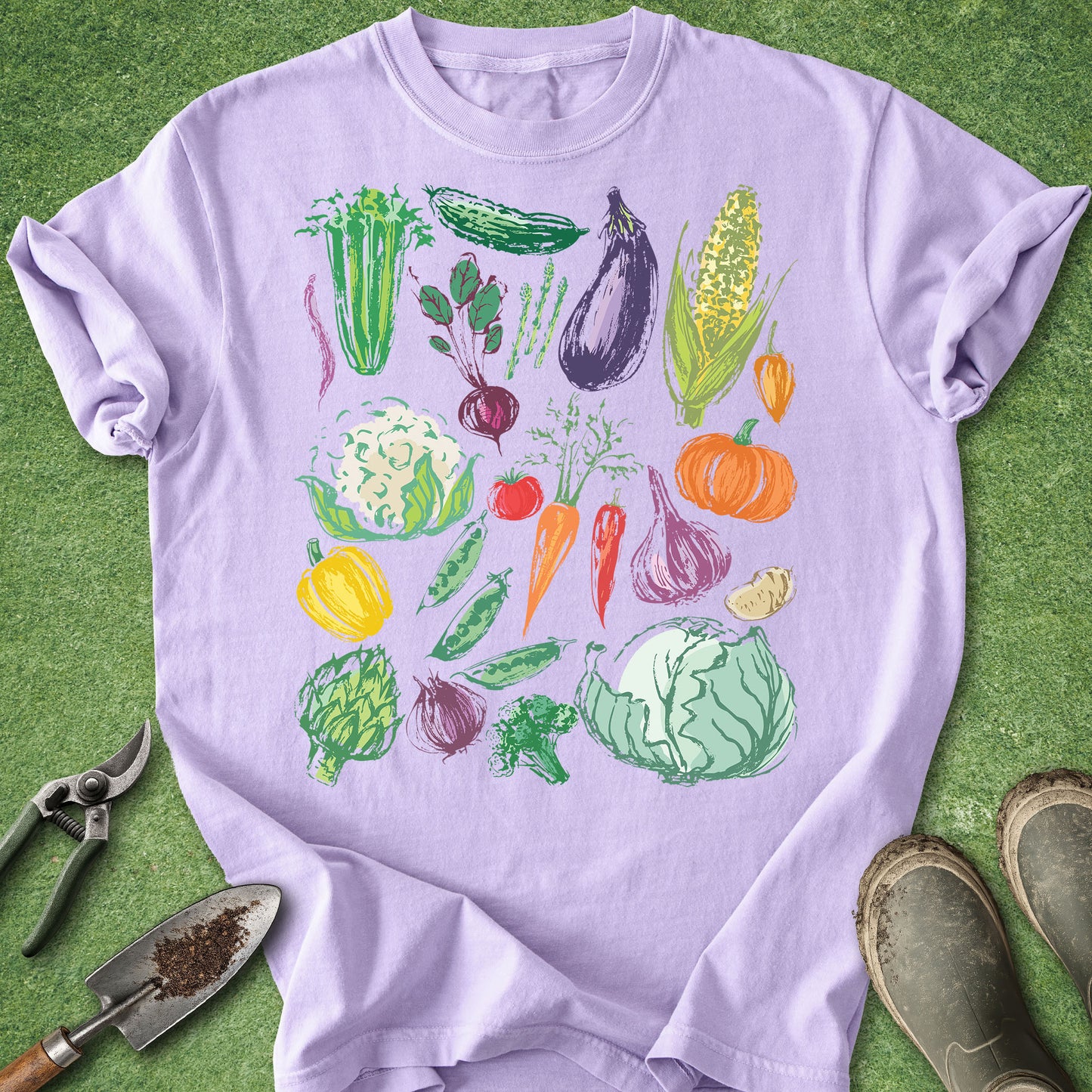 Purple t-shirt with colorful vegetable illustrations on a green background