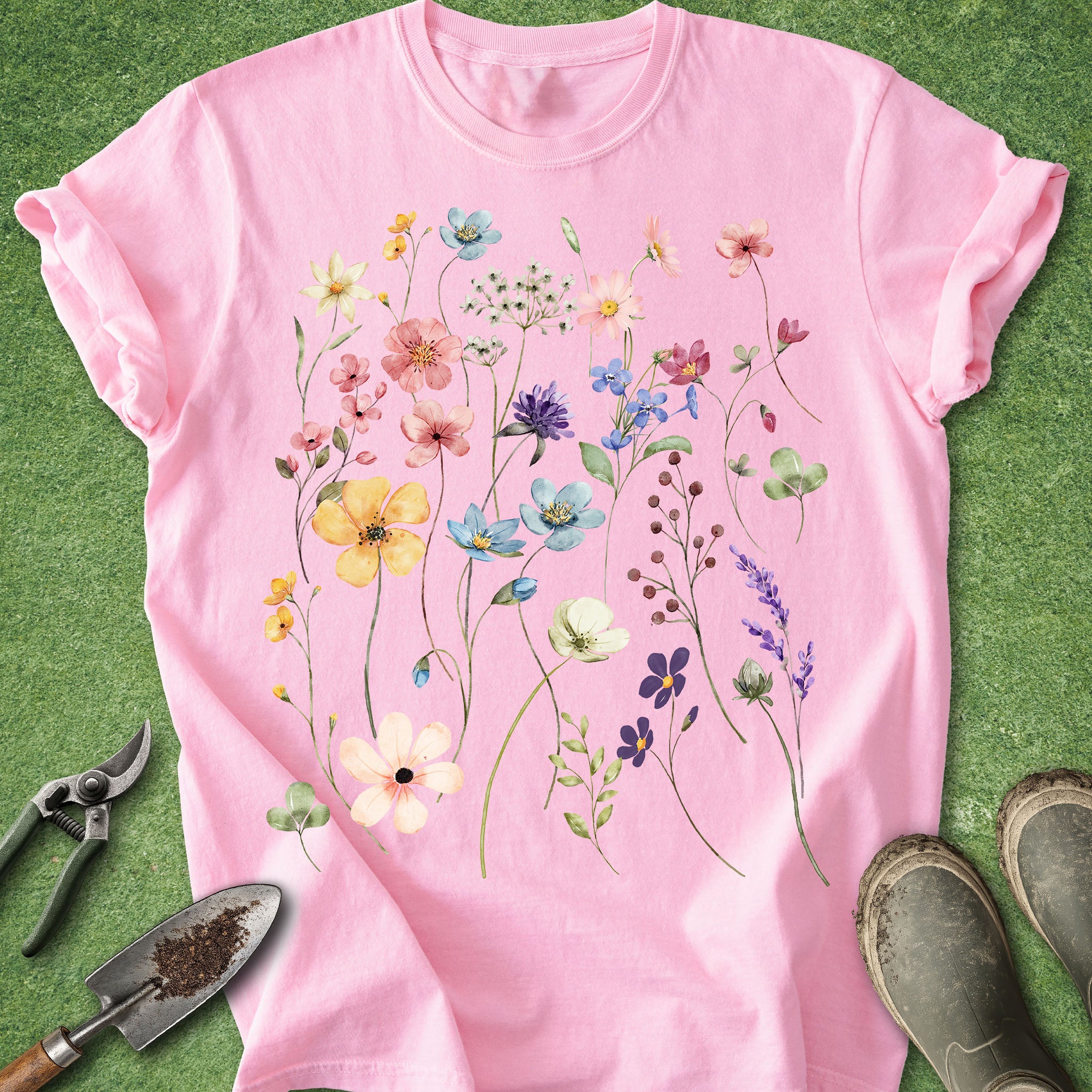 Pink t-shirt with floral design on a green background