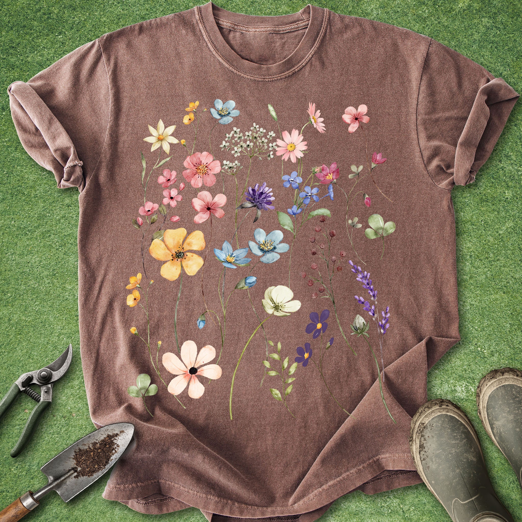 Brown t-shirt with floral design on a green grass background