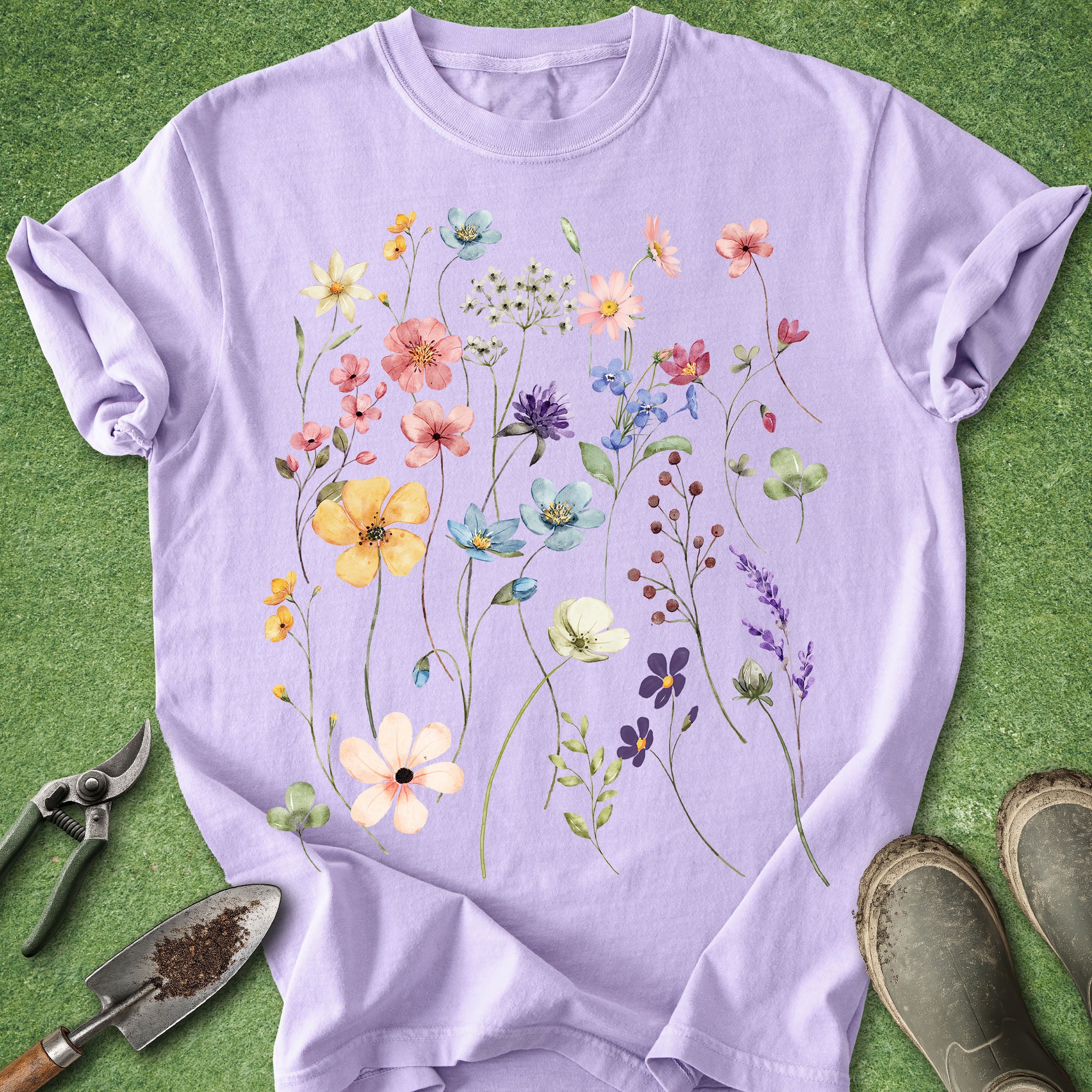Purple t-shirt with floral design on a green background