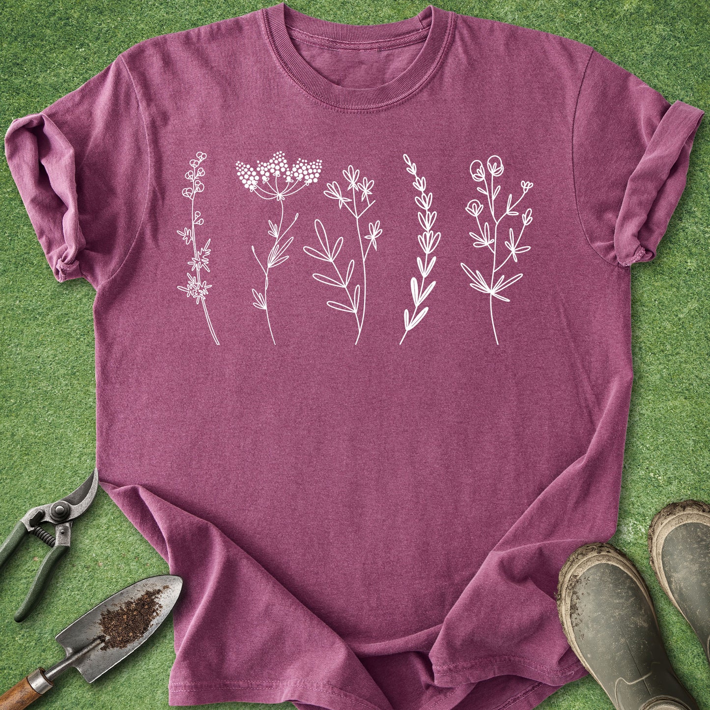 Minimal white wildflower line art graphic on blue botanical t-shirt