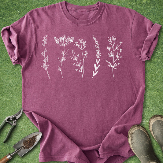 Minimal white wildflower line art graphic on blue botanical t-shirt