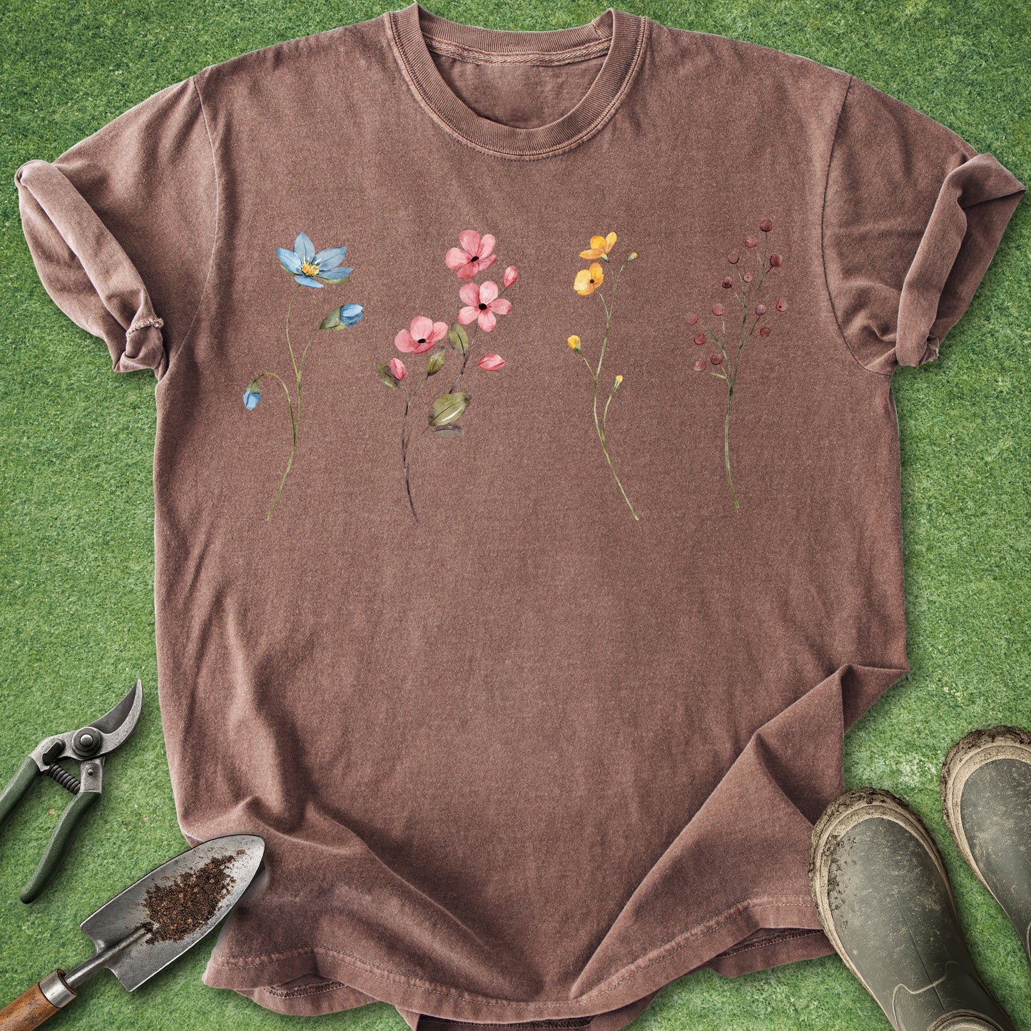 Brown t-shirt with floral design on a green grass background