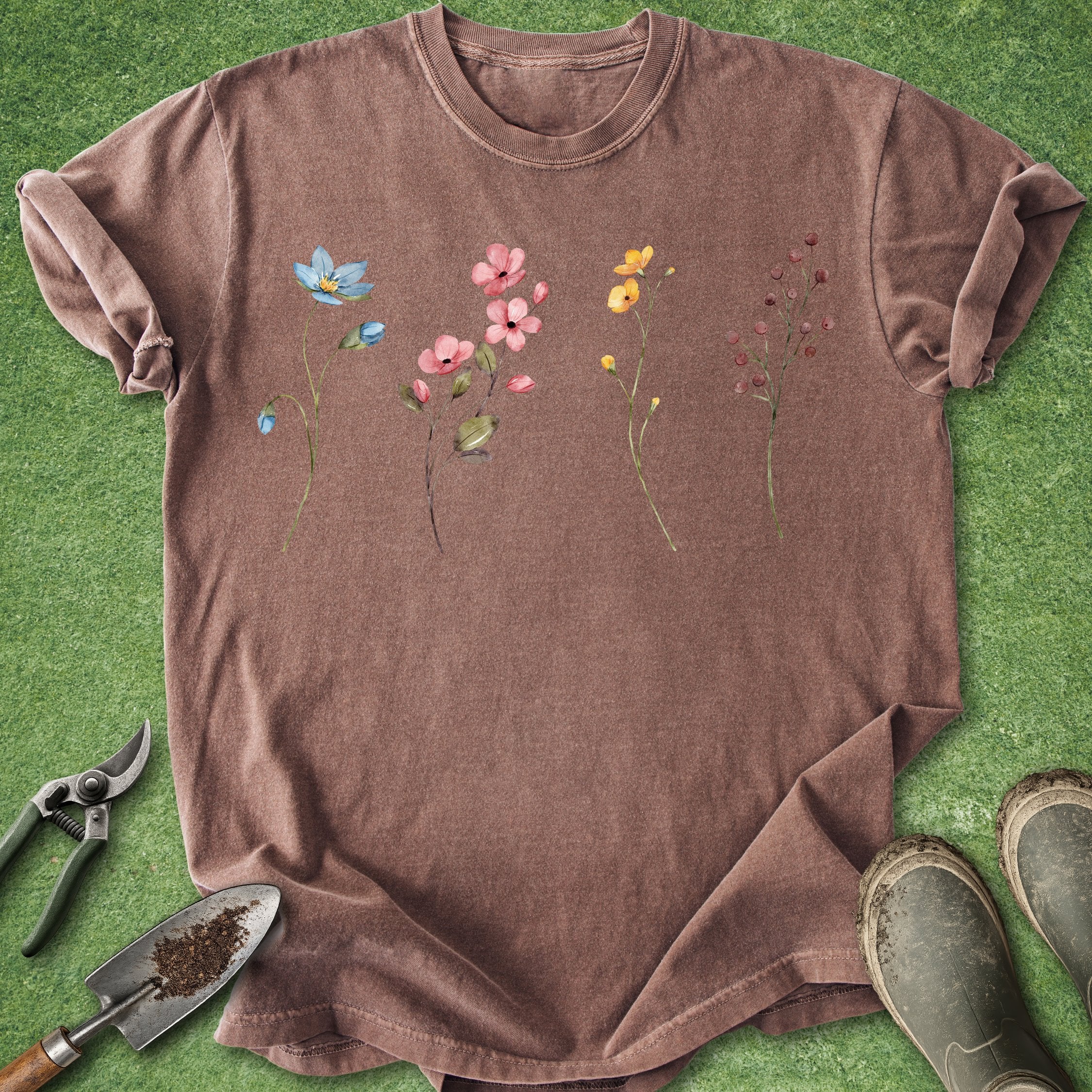 Brown t-shirt with floral design on a green grass background