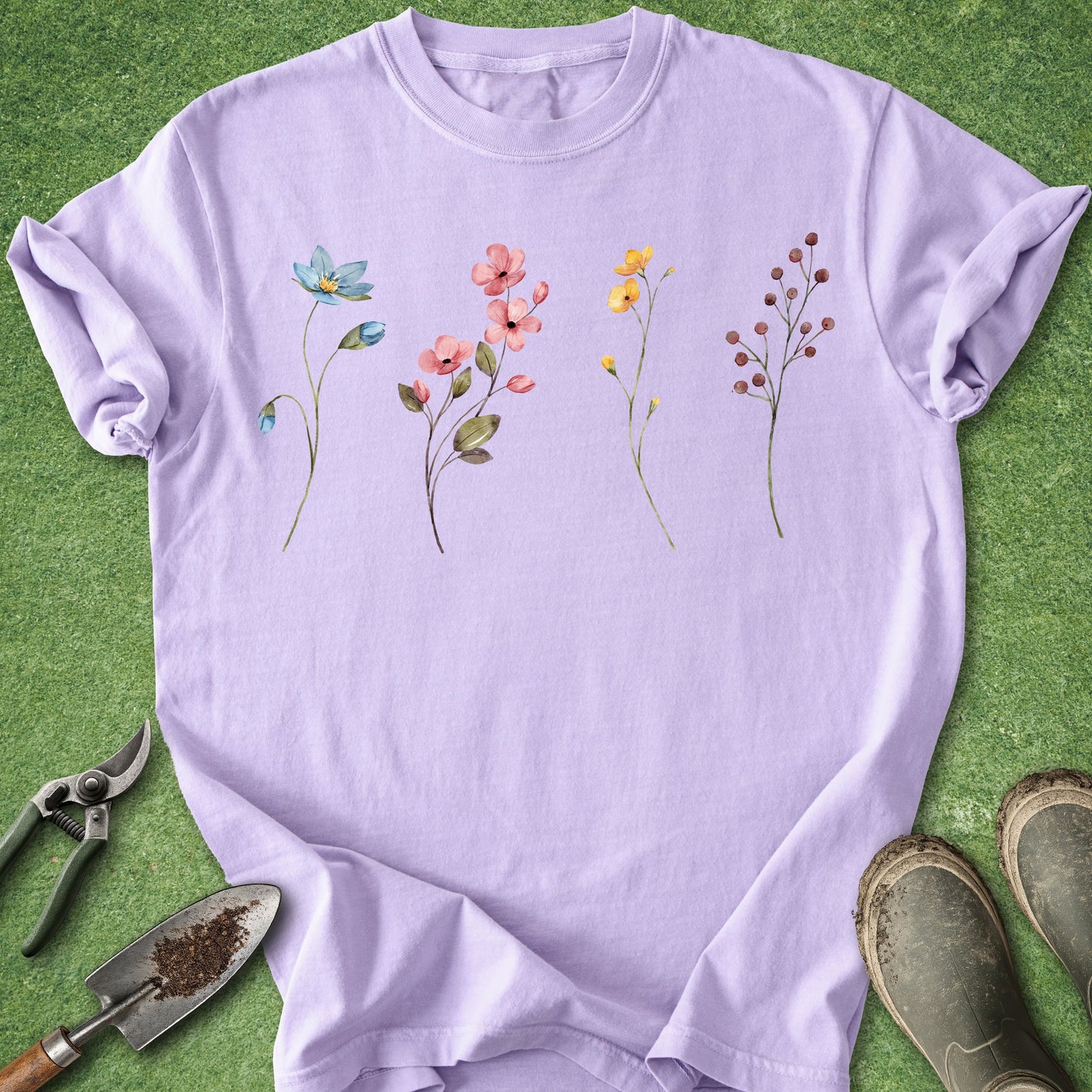 Purple t-shirt with floral designs on a green background