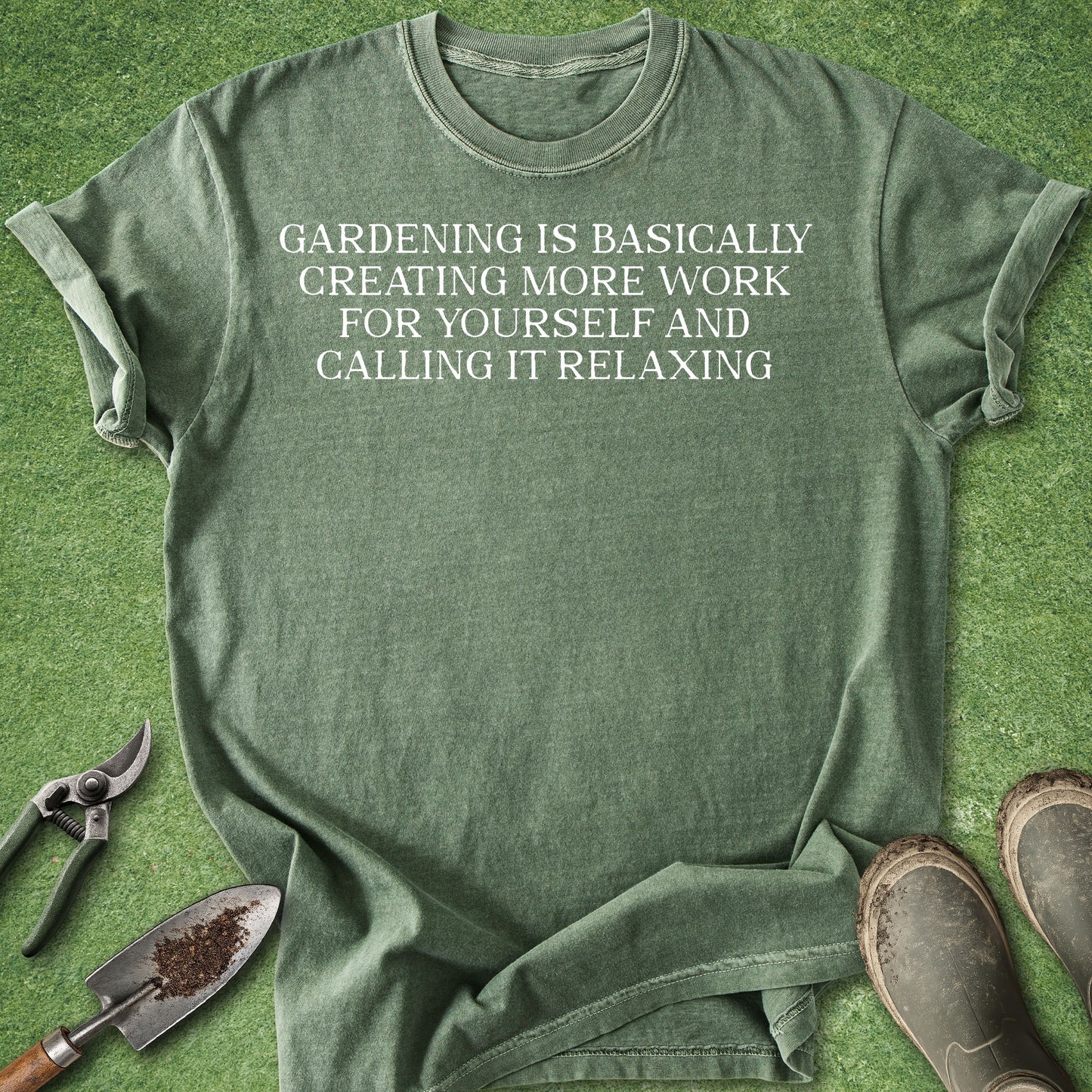 Green t-shirt with 'quietly planning my next harvest' text on a grass background with gardening tools.