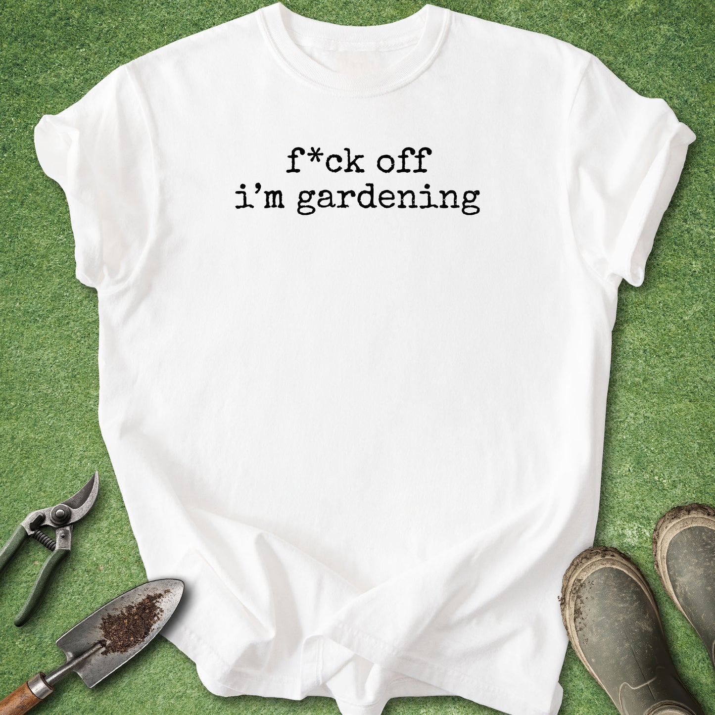 White t-shirt with 'quietly planning my next harvest' text on a green background with gardening tools.