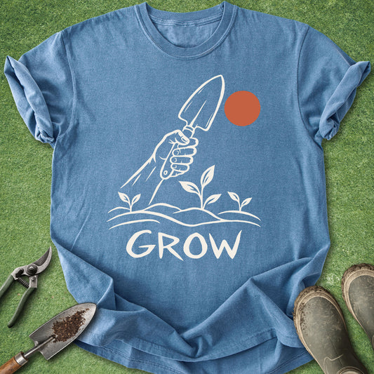 Blue Grow gardening shirt featuring a hand holding a garden trowel above seedlings with a simple sun graphic.
