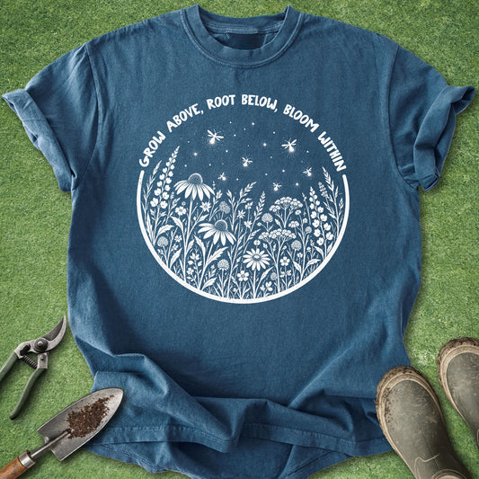 Blue gardening shirt with white wildflowers and fireflies surrounded by the phrase Grow Above, Root Below, Bloom Within.
