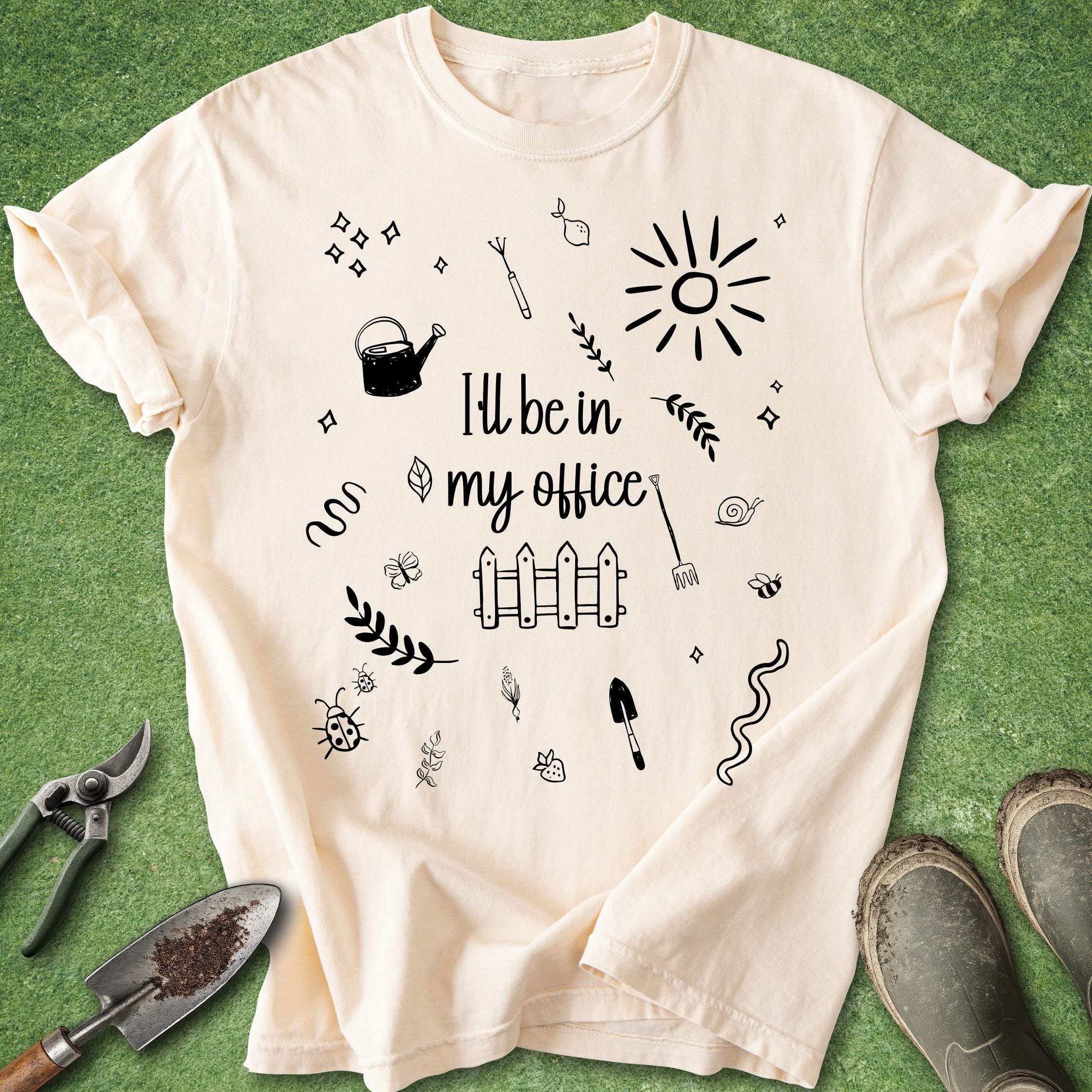 Beige t-shirt with gardening-themed designs and text on a green background