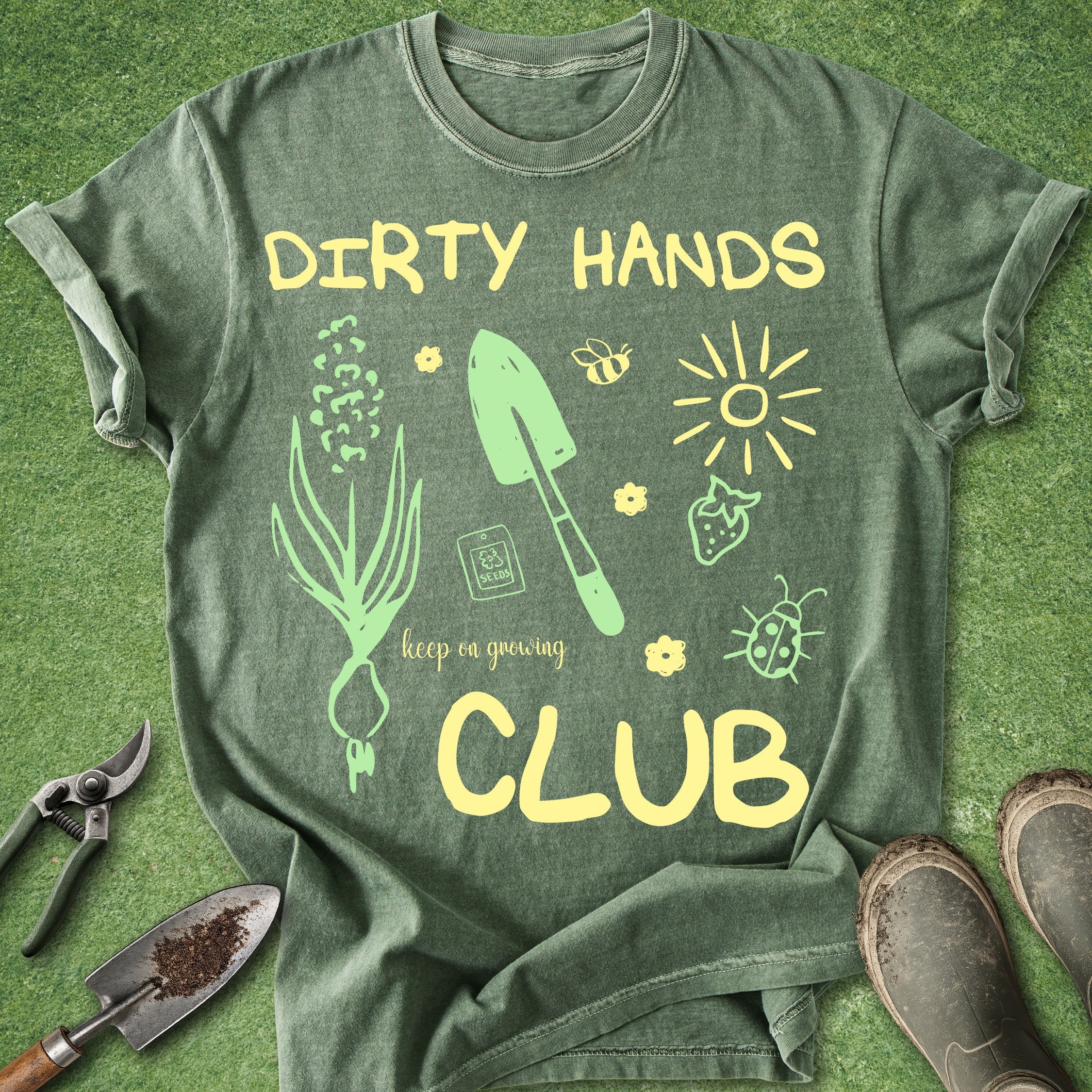 Green t-shirt with gardening-themed design and tools on a green background