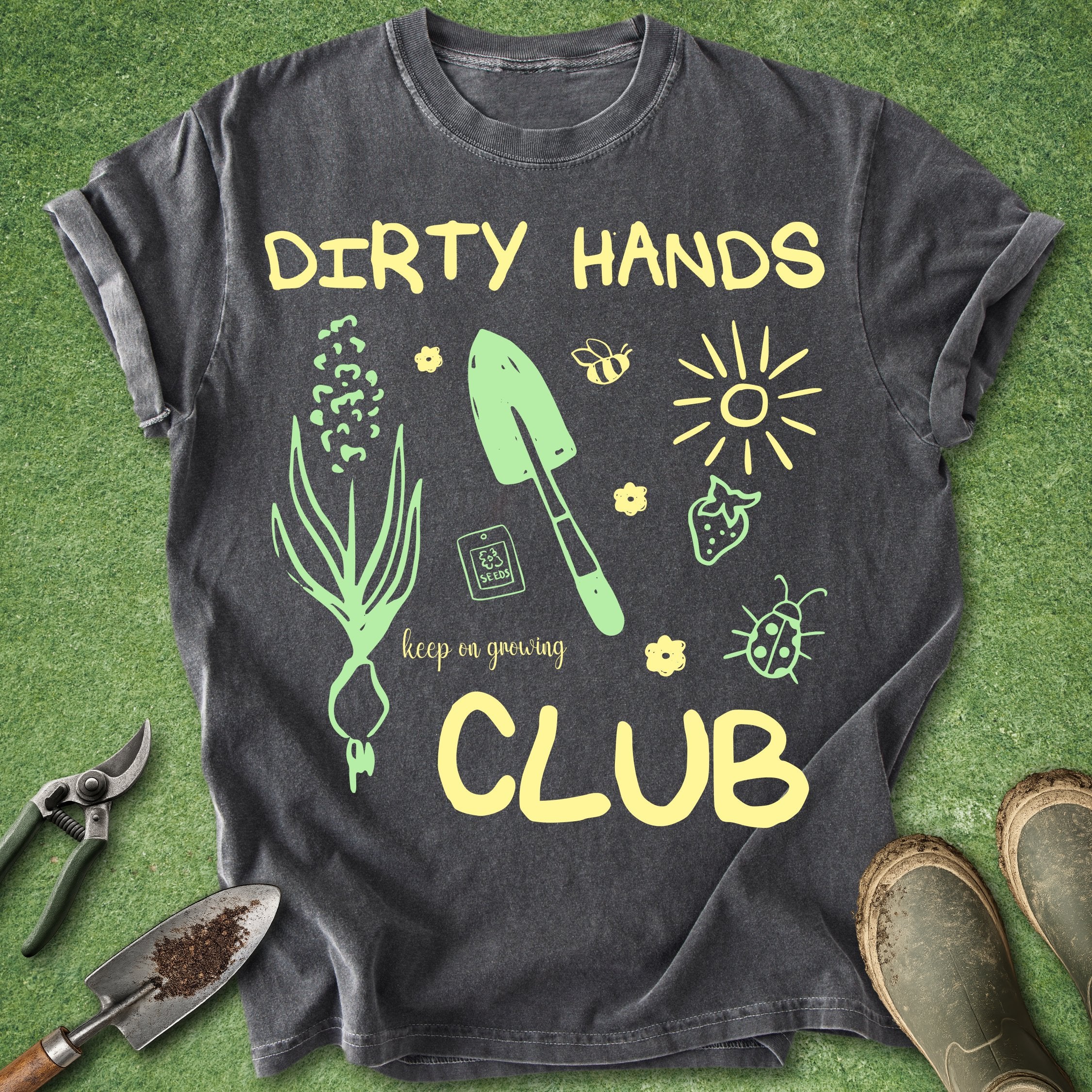 Black t-shirt with gardening-themed design and text on a green background