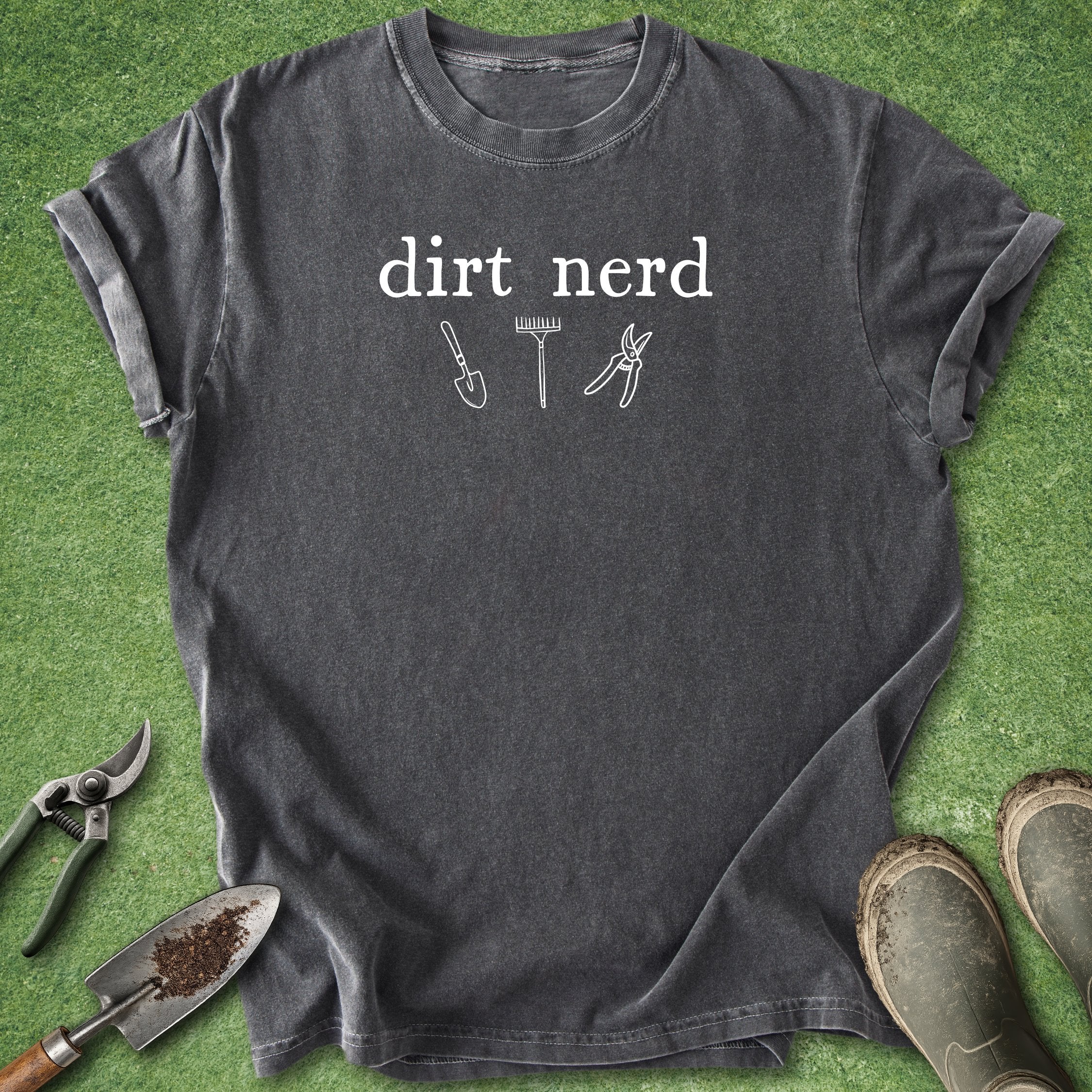 Gray t-shirt with 'dirt nerd' text and gardening tools on a green grass background
