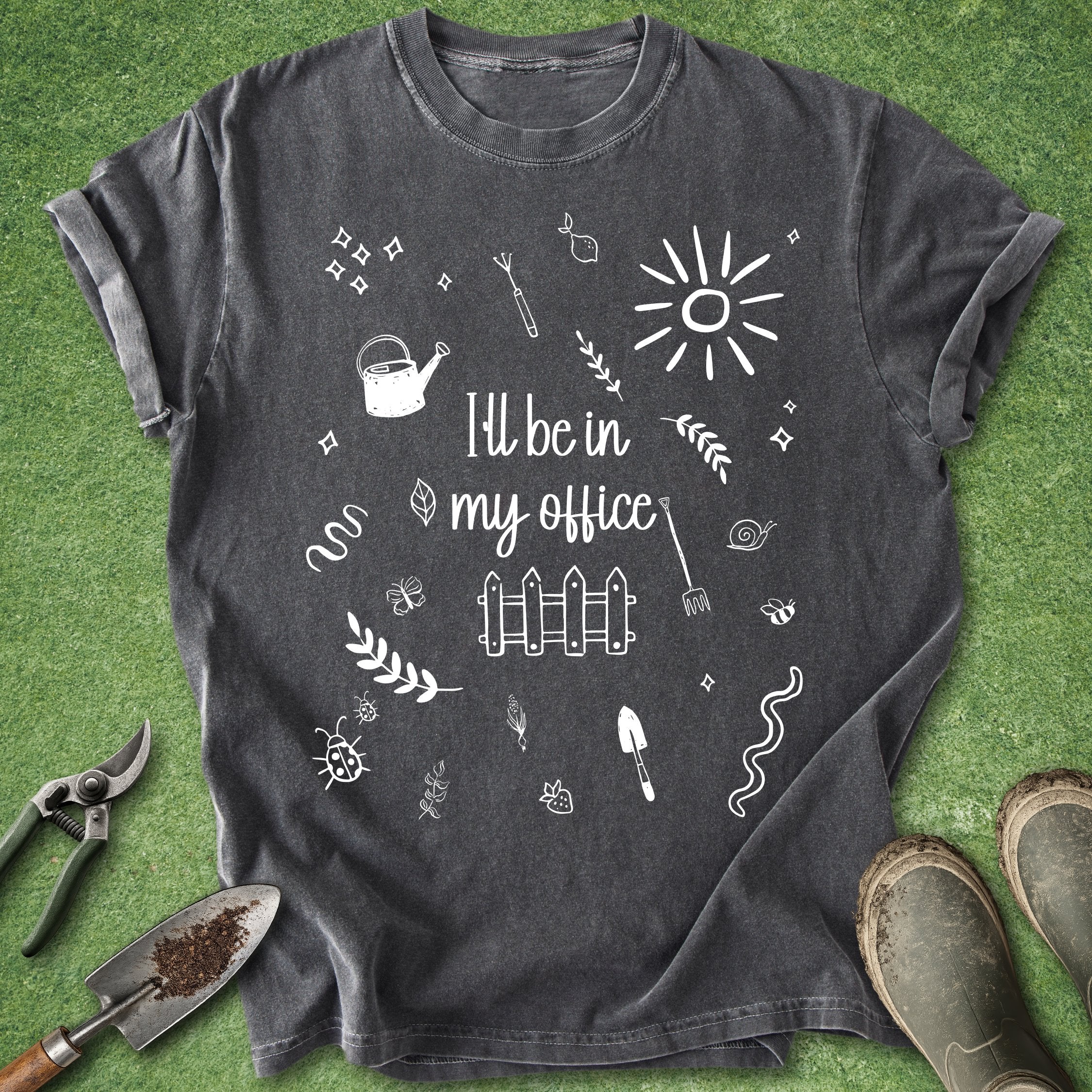 Dark gray t-shirt with white gardening-themed design on a green grass background