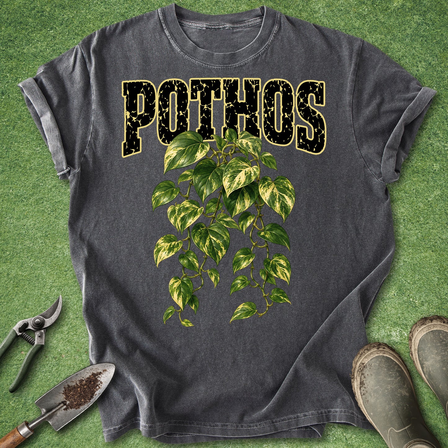 Dark gray t-shirt featuring a lush trailing golden pothos plant with green and yellow variegated leaves beneath bold Pothos lettering.