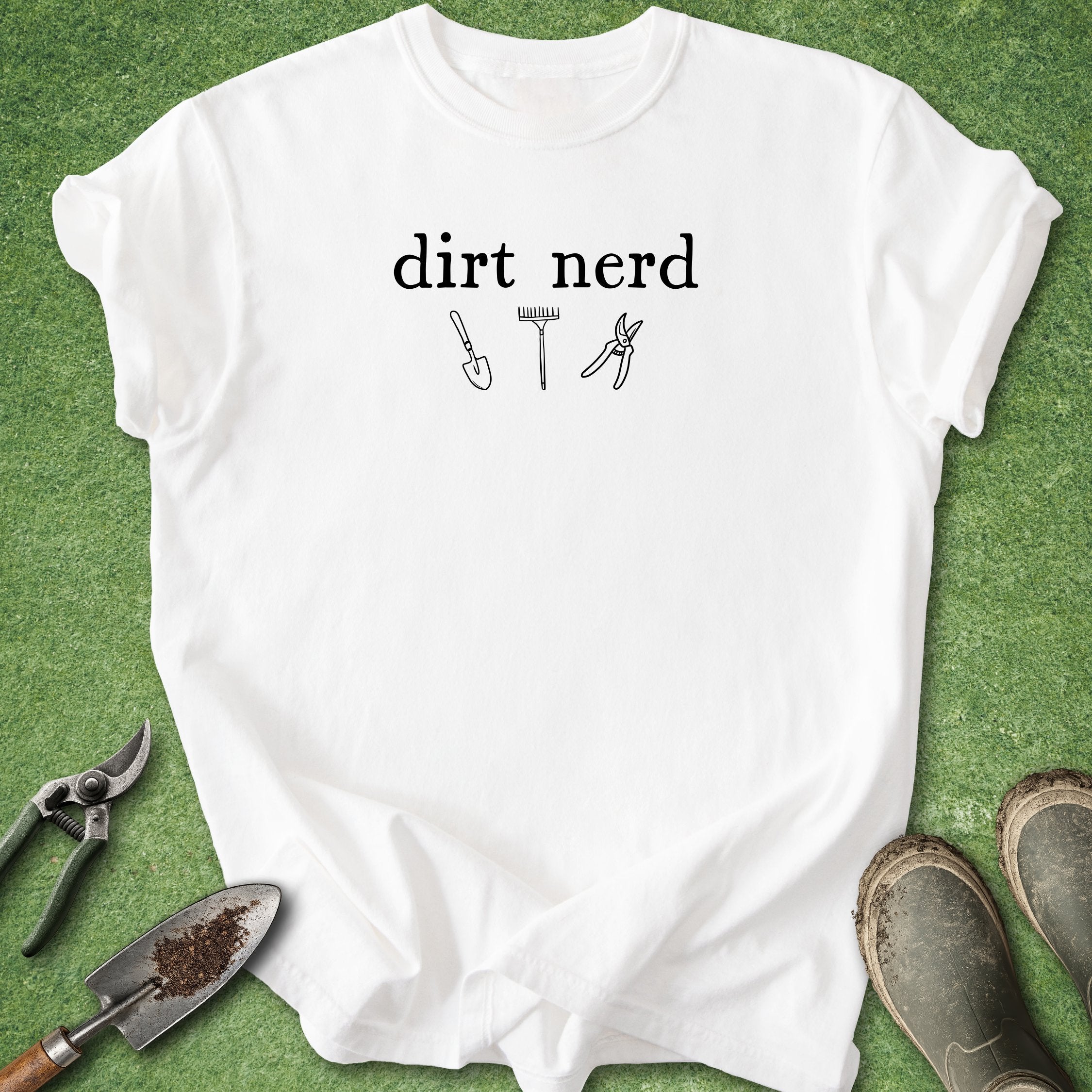 White t-shirt with 'dirt nerd' text and gardening tools on a green background